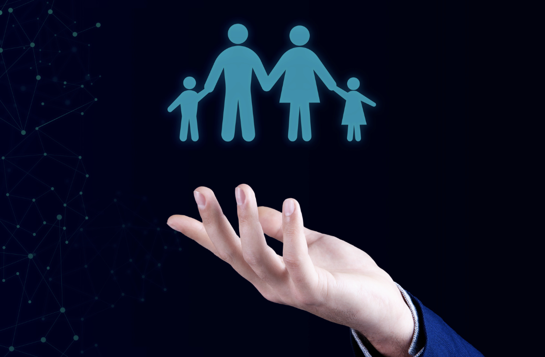 Hand palm up holding icon style images of a family with two adults and two children coloured blue